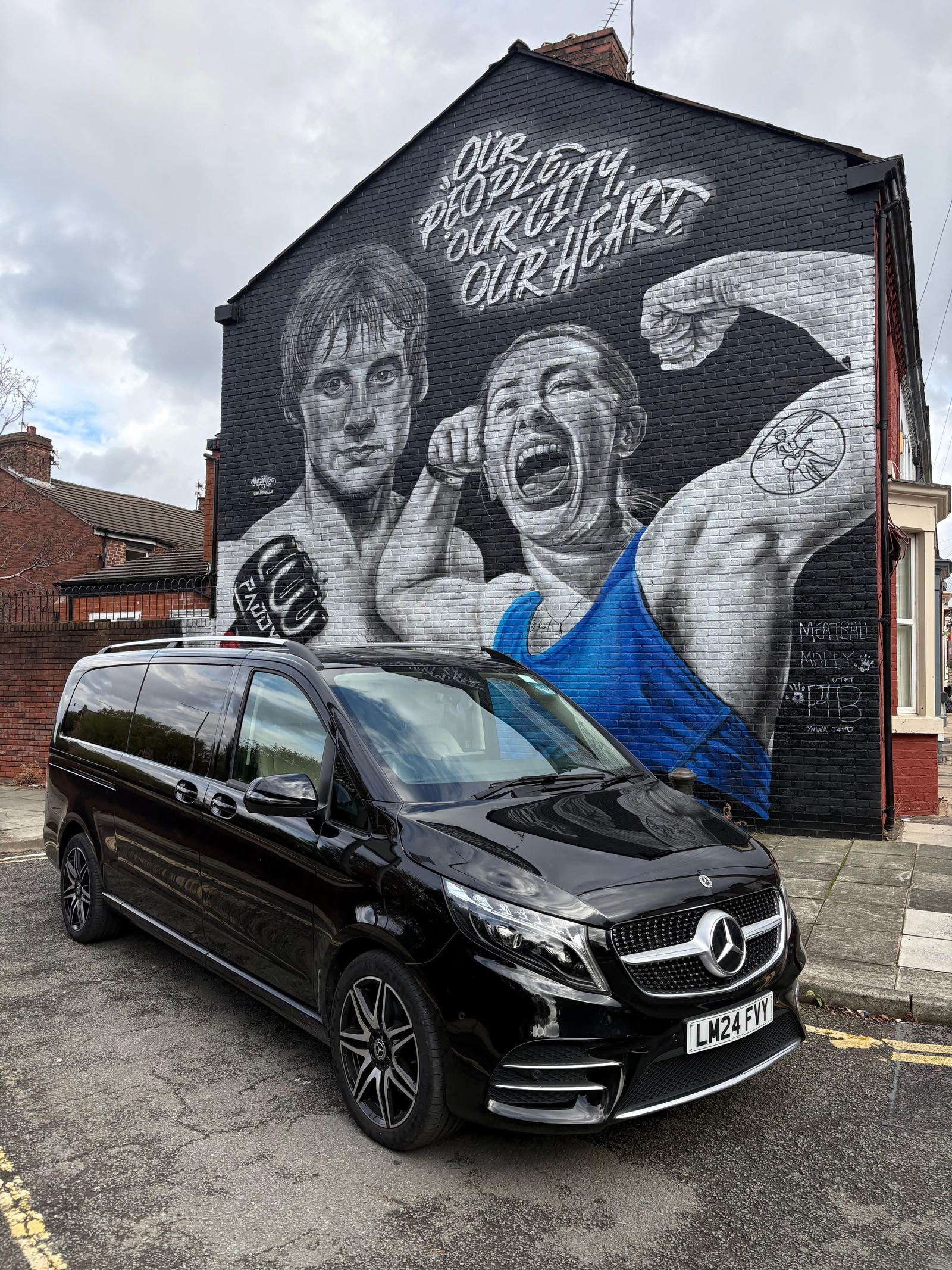 AO Platinum Chauffeurs Jet-Class beside a Liverpool FC mural near Anfield